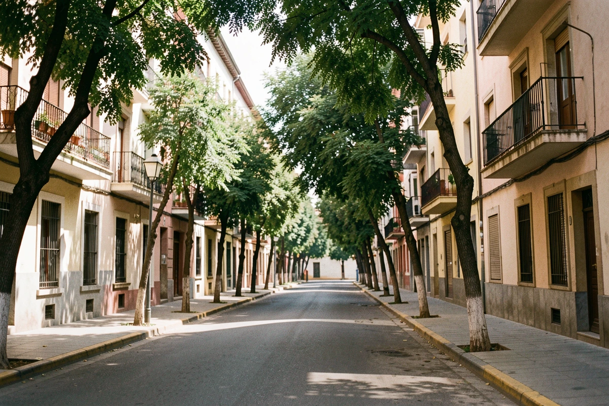 Residential apartment facades and balconies on a tree-lined Córdoba street
